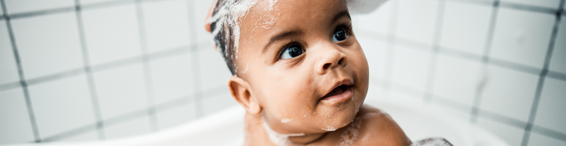 a young aboriginal woman who is taking a bath in a s